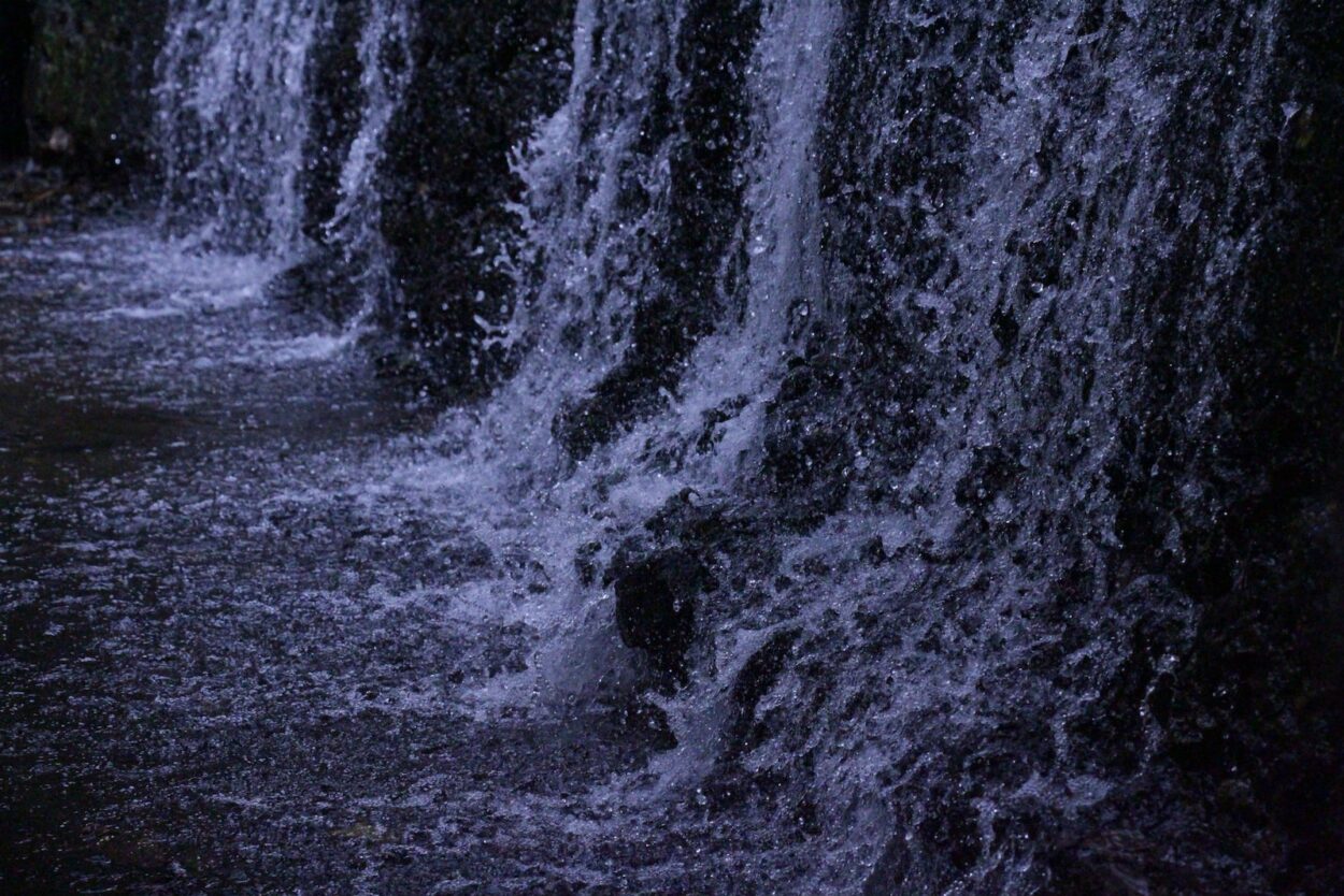 a close up of a waterfall with water coming out of it